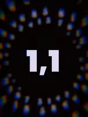 The cover image features a dark background with a blurred, colorful radial pattern around a central focus. In the center, large, white numbers are displayed, specifically '1,1'. The text is simple, but the composition and blurred effect create visual emphasis.