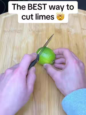 The cover image shows a close-up view of a wooden cutting board with a hand holding a green lime while a knife is cutting it. Above the lime, text overlaid reads: The BEST way to cut limes with a slightly concerned emoji.