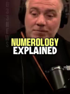 The image features a man wearing headphones, set against a blurry background. The overlaid text reads "NUMEROLOGY EXPLAINED" in a bold, yellow font with a black outline; the text is centered. A microphone is visible in the bottom corner.