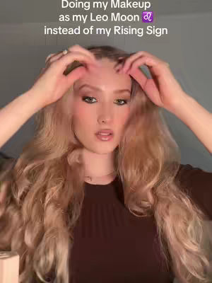 A woman with long blonde hair is shown looking at the camera, holding her hands near her forehead. The image has text overlayed at the top.