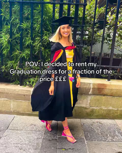 A woman in a graduation gown and cap stands in front of green foliage and a black wrought-iron fence. She has blonde hair and is smiling. Text overlays the image.
