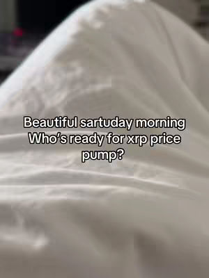 The image features a close-up view of a white, rumpled bedsheet. The fabric is soft, with gentle shadows and highlights suggesting texture and volume. Overlayed in the center, in a simple black font, is the text "Beautiful sartuday [sic] morning Who's ready for xrp price pump?"