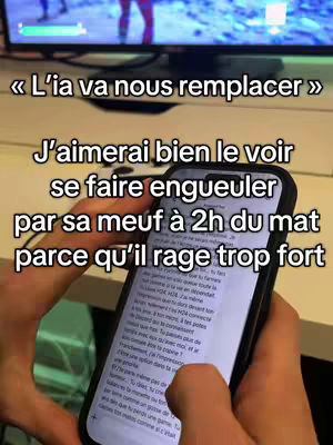 The image shows a person holding a smartphone displaying a text conversation against the blurred background of a gaming setup. The phone is the central focus, showing the text in black on a white background, while the person's hands and a portion of a computer screen with video game visuals are also visible.