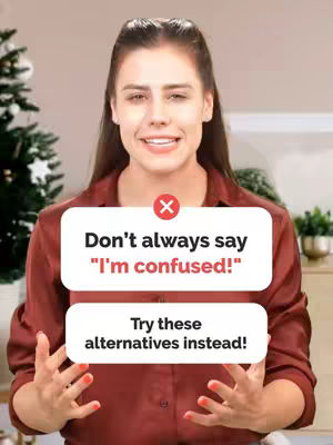 A woman with long brown hair is centered in the frame, smiling. She has two white informational boxes laid over her chest. The top box has a red 'X', the text reads 'Don't always say "I'm confused!"'. The box below reads 'Try these alternatives instead!'. The background is light tan and blurry.