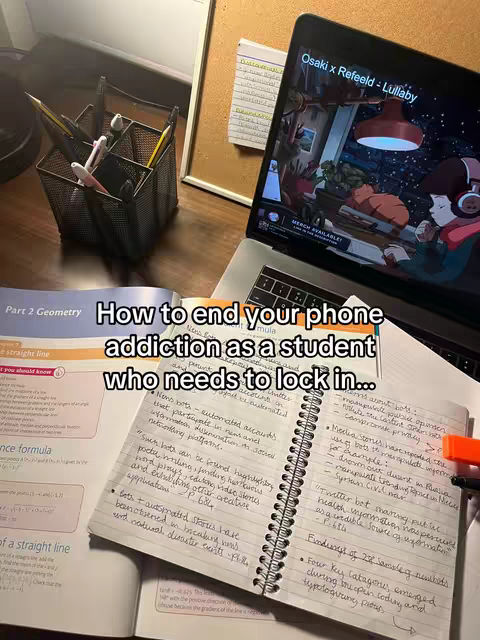 The image presents a study setup with a laptop displaying an animated scene, an open notebook with handwritten notes, and textbooks. The foreground features a desk with study materials like pencils, pens and a book. The background consists of a corkboard with notes.