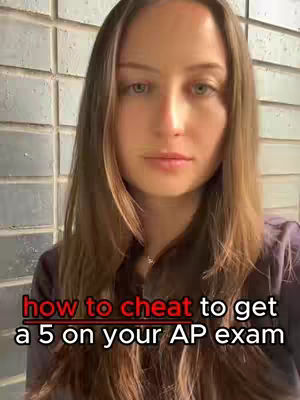 A medium shot features the creator standing against a light-colored, textured brick wall. The creator, seen from the chest upwards, has long brown hair and fair skin. A text overlay in red and white is positioned at the bottom, with the creator looking directly at the camera.