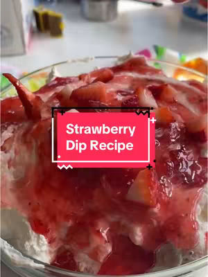 A clear glass bowl filled with a layered dessert. The bottom layer appears to be a creamy white base, likely a whipped cream or cream cheese mixture. On top of this base are chunks of fresh strawberries, followed by a layer of vibrant red strawberry sauce or glaze, with more strawberries on top. A red box with white text overlays the center of the image, it says "Strawberry Dip Recipe".
