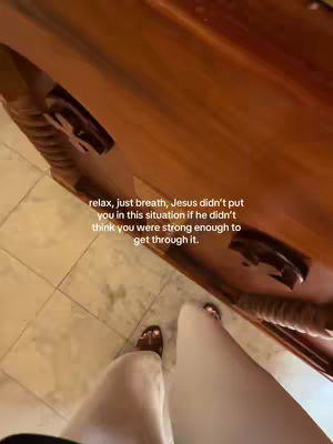 A low-angle shot shows a person's feet and lower legs against a background of a wooden surface and tiled floor. The person is wearing sandals. Text overlayed on the image reads, 'relax, just breath, Jesus didn't put you in this situation if he didn't think you were strong enough to get through it.'