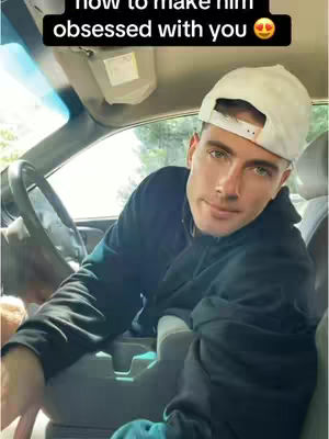A man wearing a white cap is sitting inside a car, looking at the camera. Text overlayed at the top says, 'how to make him obsessed with you 🤩'