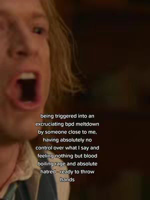 A close-up shot focuses on a man with pale skin and blond hair, his facial expression contorted in a wide-mouthed yell. His eyes are not visible and his cheeks are flushed red. Overlayed text is positioned to the lower right, describing emotional distress. The background is a dark, out-of-focus interior.