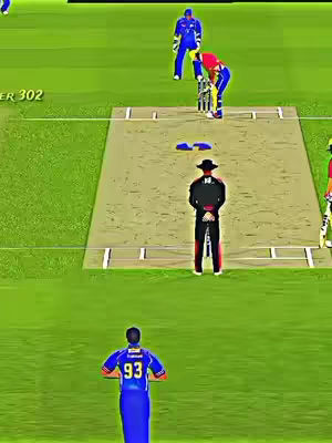 A cricket match scene from a high angle, showing players in action on a green field. The foreground shows a player in blue uniform with number 93 on his back. The center features another player in red and yellow, ready to hit the ball. An umpire with a black hat stands behind them. The background reveals other players in blue uniforms. The field has a light brown pitch and a green outfield, with all elements lit evenly.