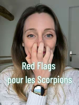 A woman is shown in a selfie-style shot, covering her nose and mouth with her hand. Text overlays read 'Red Flags pour les Scorpions'. The background is a domestic interior setting.