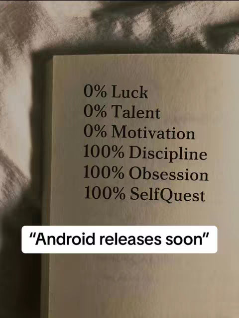 The image displays a portion of a book page where the text listing percentages relating to success against SelfQuest is printed. Below this text is a rectangular box with the text "Android releases soon". The background is a white wrinkled fabric.