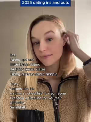 A woman with blonde hair is the central focus, her face angled towards the viewer. She wears a tan, fuzzy jacket over a dark top. The image has text overlays in a list format: '2025 dating ins and outs' at the top, and lists specific 'Ins' and 'Outs' related to dating. The background is neutral and blurred, emphasizing the subject and the content.