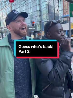 An outdoor shot features two men, one fair-skinned with a black baseball cap and beard, smiling broadly. The other man is dark-skinned with sunglasses on his head, also smiling, and is partially obscured, suggesting a candid or street-style capture. Overlaid text states 'Guess who's back! Part 2' in a rectangular box with a blue background and red trim, placed centrally.
