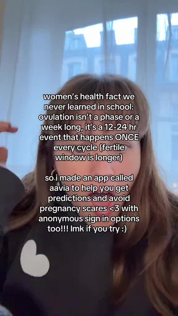 The cover image features a person with light brown hair, partially visible, and a black top with a white heart-shaped design. Text overlays detail women's health facts, ovulation, and an app called aavia.