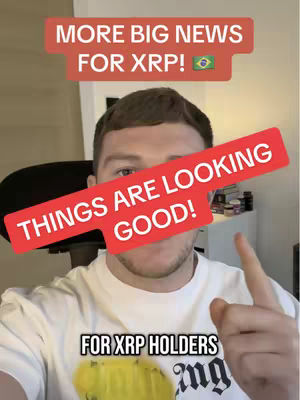 A man with short brown hair is centered in the frame, wearing a white t-shirt. Above him are two rectangular text overlays. The top one is light red and reads, “MORE BIG NEWS FOR XRP!” with a small flag for Brazil. Below this, a slightly angled red rectangle covers most of his face with the text, “THINGS ARE LOOKING GOOD!” A smaller text box below this reads, “FOR XRP HOLDERS.” The background includes a partially visible room.