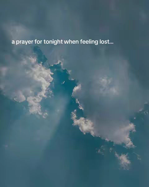 A scenic image with a blue sky filled with fluffy white clouds. The text overlay reads 'a prayer for tonight when feeling lost...'