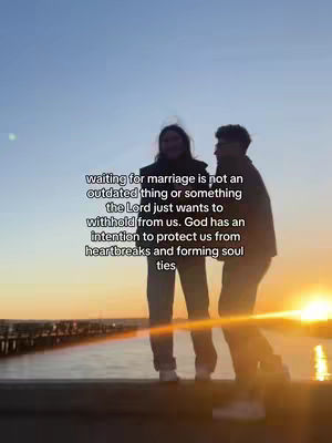 A couple standing close together on a pier, silhouetted against a vibrant sunset. The sky is a gradient of orange and blue. Text overlayed in the center.