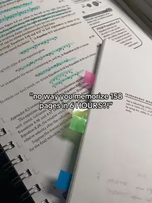 An overhead shot shows an open textbook on a desk, with notes and highlighted text. A piece of paper with a question in the center is placed on the textbook in front of the pages being presented. A few colored sticky notes are marking different pages.