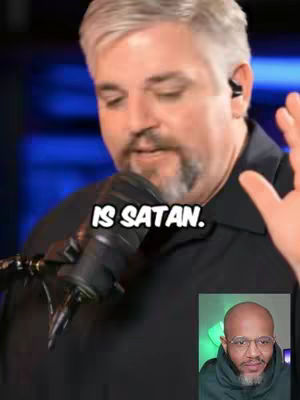 The cover image shows a man speaking into a microphone with a text overlay. In the bottom right corner, there's a smaller inset image of another person. The main figure has fair skin, short gray hair, and a salt-and-pepper beard. The text overlay at the center of the image states "IS SATAN."