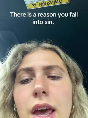 The cover image presents a close-up shot of a woman's face. She has light skin, blonde wavy hair, and is looking towards the camera with a neutral expression. The background is dark, and the image appears to be taken indoors, possibly in a car, as a warning sticker is visible. Text overlayed on the image reads, "There is a reason you fall into sin."
