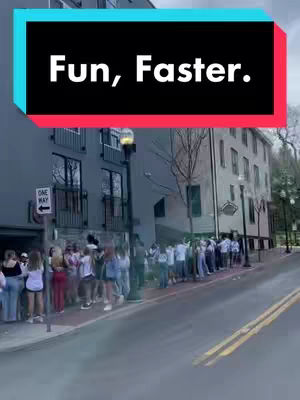 The image shows a street scene with a long line of people queuing outside a building. Above the scene is a colored text overlay that reads: 'Fun, Faster.'