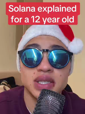 The cover image shows a young man with fair skin wearing a Santa hat and sunglasses. The sunglasses reflect a bright indoor environment. He is holding a microphone close to his mouth. Above him is a red banner with white text.