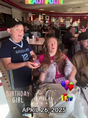 The cover image shows a scene inside what appears to be a restaurant. A woman in a wheelchair, wearing a pink shirt and a gray blanket, is being presented with a birthday cake by someone standing next to her, with other people in the background. The image is overlaid various text and graphic elements.