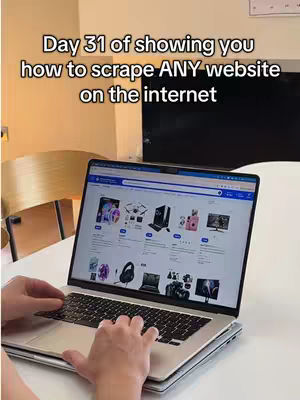 The cover image shows the hands of a person typing on a laptop sitting on a white table. The screen of the laptop displays a website interface. There is additional text overlayed onto the picture stating "Day 31 of showing you how to scrape ANY website on the internet". In the background there's a table and chair visible, suggesting an indoor setting.