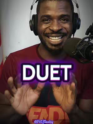 A man wearing headphones and a maroon shirt is the central focus, smiling with his hands up in front of a microphone. A highlighted 'DUET' overlay is positioned centrally. The background is plain with a slightly blurred effect, and text reading '@Pst.Stanley' is written on the bottom.