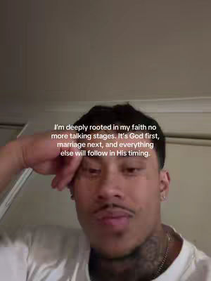 A person in the video is looking at the camera with text overlayed on the screen. The background of the video is out of focus.