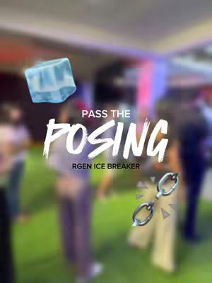A blurred photo shows a gathering on a green surface, with text overlays. A translucent blue ice cube graphic floats near the top-left. The words 'PASS THE' are in white, capital letters, above the word 'POSING', in large, bold white letters, styled as if handwritten. Below that, in a smaller white font, the text 'RGEN ICE BREAKER'. Adjacent to the right, is a pair of silver chain links.