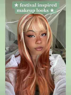 The image is a close-up of a person with long, reddish-blonde hair. A text overlay at the top reads "festival inspired makeup looks" in a green rectangle. The person is looking at the camera with makeup on. The background is blurred, with hints of a bed and curtains visible.