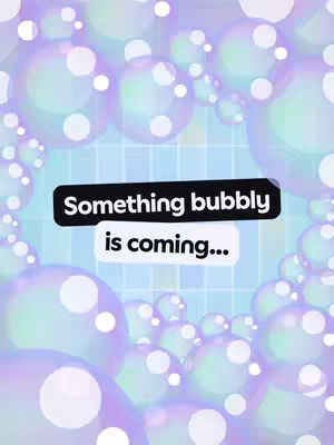 The cover image is a colorful, stylized graphic with a bubble theme. Spherical bubbles, ranging in size, fill the space, with a few larger, more prominent bubbles in the foreground. These bubbles have a pearlescent, iridescent quality, displaying a palette of greens, blues, and purples. In the center, a grid-like pattern is faintly visible, overlaid by two text boxes. The first box, in black, reads "Something bubbly", and the second, in white, states "is coming...". The overall composition is playful and eye-catching, with the bubbles creating a sense of depth and the text boxes providing a clear message.