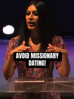 A woman standing behind a clear podium with text overlay. She is speaking, captured from the chest up. The background is dark with a blurred spotlight. The overlay text is white on a black background.