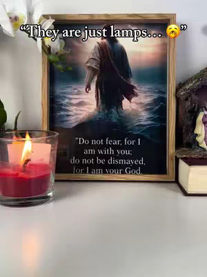 The cover image shows a framed picture of Jesus walking in water on a table. A lit red candle in a clear glass is in the foreground on the left. To the right of the frame is a small nativity scene and a book, the background is a blurred wall.