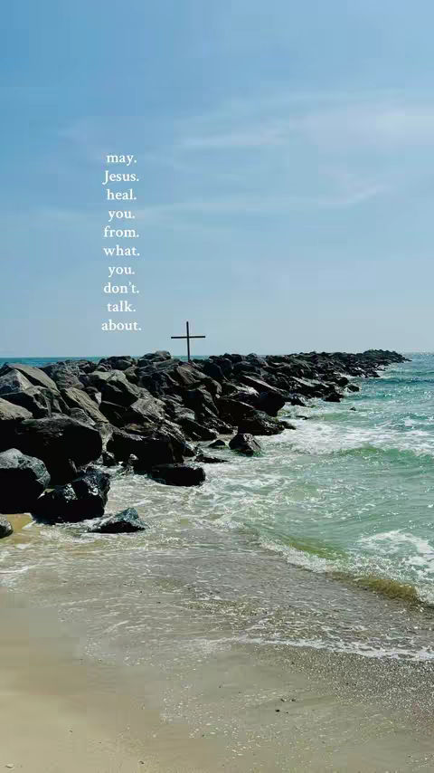 An image of a rocky shoreline with a cross in the distance. The water is a clear turquoise, and the sky is a bright blue. Text is overlaid on the image, reading as a poetic phrase.