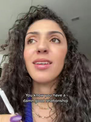 A selfie-style shot features a woman with curly dark hair, turned slightly towards the left, against a neutral background. She has pronounced eyelashes, lipstick, and a small nose ring. Beneath her, text reads, 'You know you have a damn good relationship'.