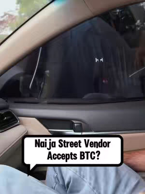 The cover image is taken from inside a car, showing a view through the tinted window.  A white speech bubble with a black border is overlaid, containing the text  "Naija Street Vendor Accepts BTC?"