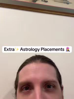 The cover image presents a close-up shot of the creator's face from the eyes down. The top of the frame shows the top of a picture frame. A text overlay in a white box reads "Extra ✨ Astrology Placements"