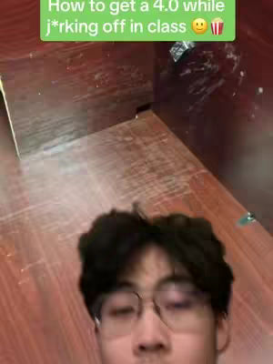 A selfie-style video with a young man in the bottom half of the frame. He wears glasses and appears to be in a classroom setting, with the focus on his face. Green text is overlaid at the top.