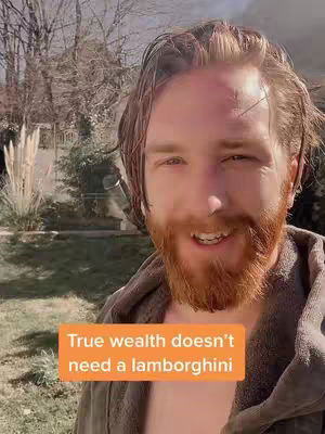 A man with a red beard standing outside in front of trees, with an orange text box overlay.