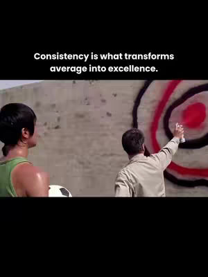 The image shows a man spraying a wall with a spray of paint with a red dot target, and a person next to him and with a ball