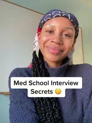A woman with dark hair is centered in the frame, wearing a blue knitted sweater and a patterned headscarf. A white rectangular text box with the words 'Med School Interview Secrets' and thoughtful eye emoji appears near the bottom of the frame.