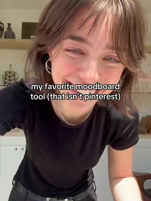 A young woman with short, layered brown hair and hoop earrings smiles into the camera. Text overlayed near her face reads "my favorite moodboard tool (that isn't pinterest)". The background is softly blurred and appears to be a home interior with neutral tones.