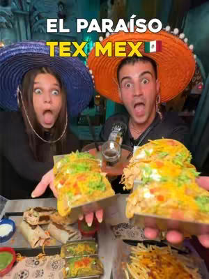 The image shows two people, a man and a woman, holding plates of tacos and making surprised faces. The background suggests a festive Tex-Mex restaurant setting. The text overlay reads "EL PARAÍSO TEX MEX" with a Mexican flag accent.