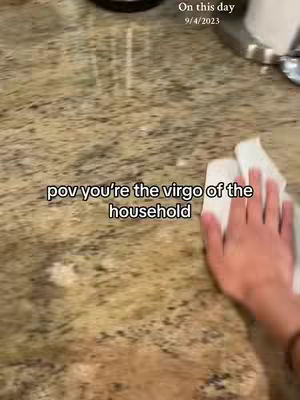 A hand with a white cloth is wiping a speckled countertop; text overlays appear as if part of the image. The date is displayed on the upper right