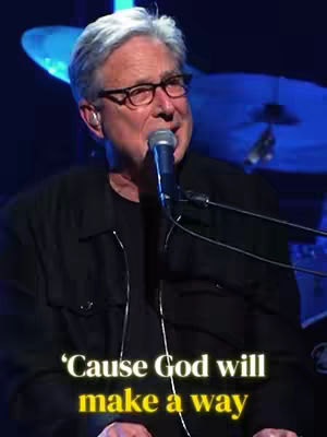 The cover image captures a man, presumably Don Moen, singing into a microphone, with text overlayed. He is wearing glasses and a dark jacket. The background suggests a stage setting with musical instruments visible. The lower part includes text that says: 'Cause God will make a way'.