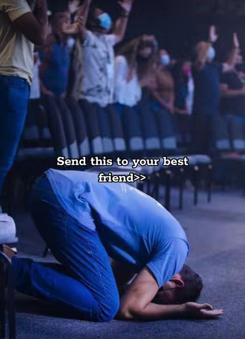 A man is on his knees in prayer, head bowed close to the floor. The background shows a crowd of people with their hands raised, some wearing face masks. Text overlay reads, 'Send this to your best friend>>'. The image is indoors with a focus on the man in prayer.
